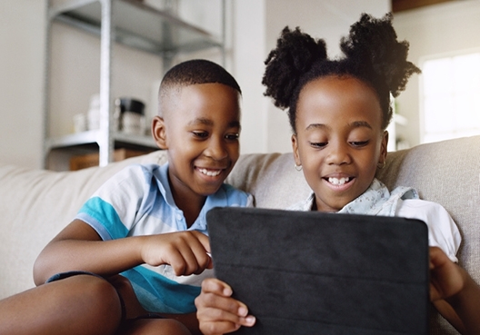 Children learning financial literacy using a tablet 