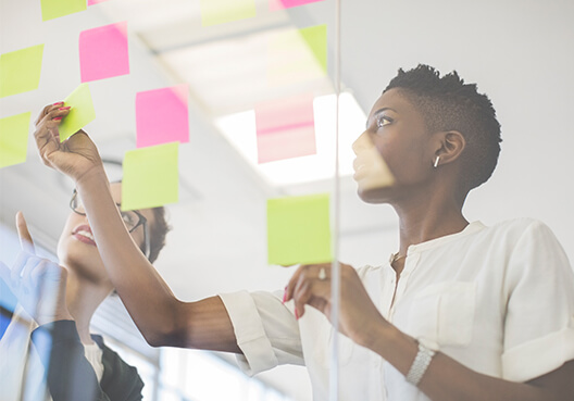 Woman sticking post-it notes on a wall